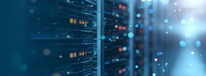 Close-up of data center servers with glowing indicator lights and abstract light effects, representing modern IT infrastructure, data processing, and technology challenges.