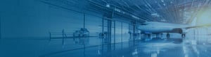 An airplane hangar with a plane at rest