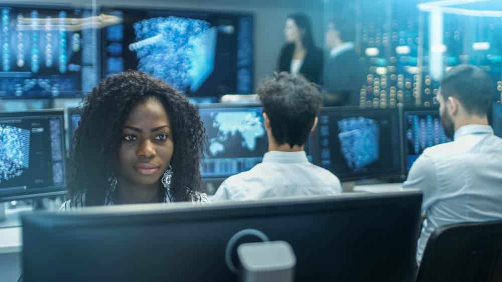 woman at monitor in server room 1000×563 Toronto Cyber Security